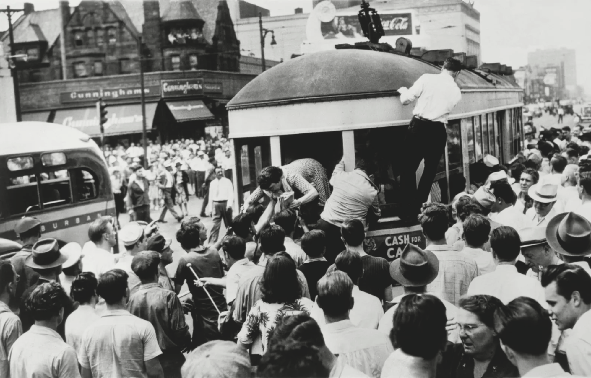 Passengers climb from rear of streetcar stopped by mob during race riots in Detroit, Michigan